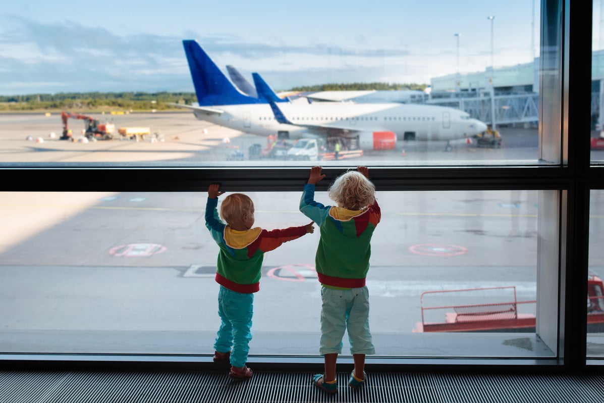 Kids travel and fly. Child at airplane in airport